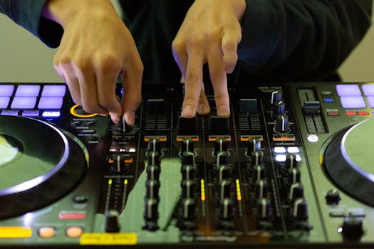 Close-up of DJ's hands mixing music on a turntable, highlighting electronic skill and nightlife.