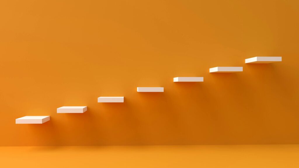 White floating steps on vibrant orange wall create a minimalist and conceptual design.